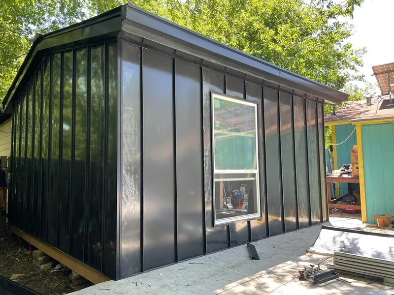 Black standing seam metal wall panels for Roof Inspection in Grove